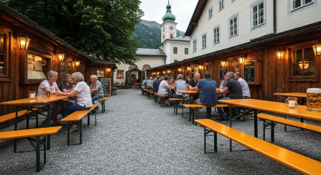 el jardín de cerveza iluminado con farolillos en Augustiner Braugasthof Krimpelstätter, grava bajo los pies, mesas largas y una jarra fresca de Märzen en la mesa